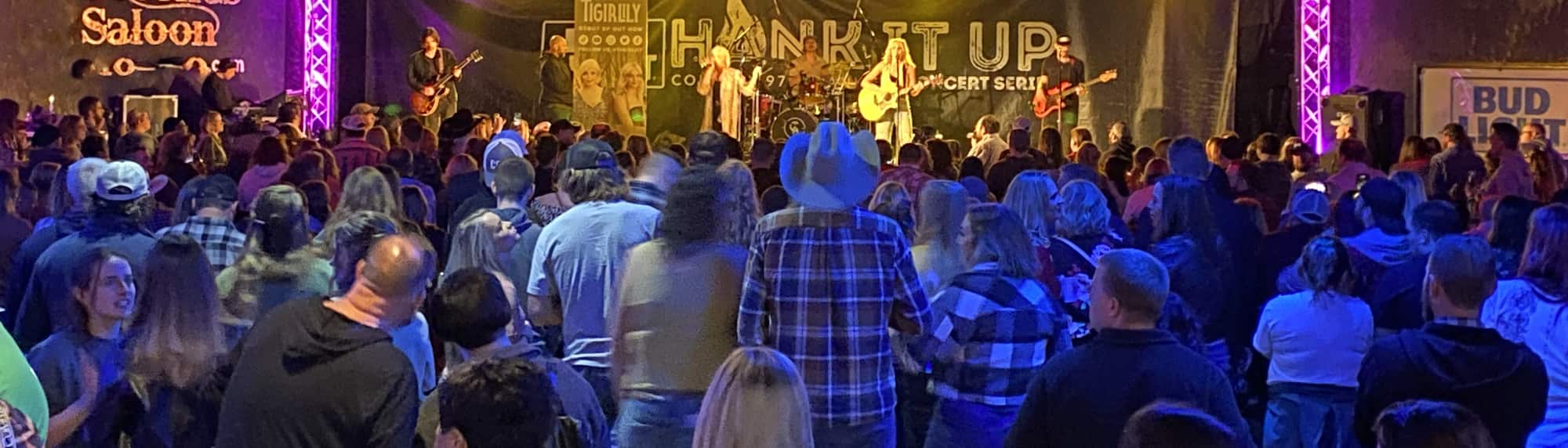 country concert with fans wearing cowboy hats Tampa