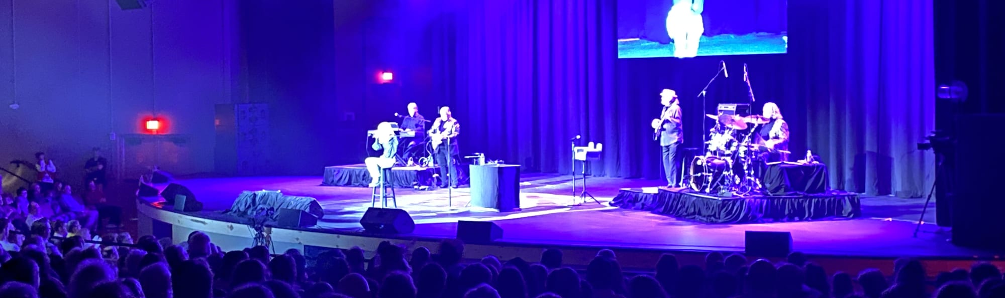 signer on stage in chair washed out by the lights Tampa